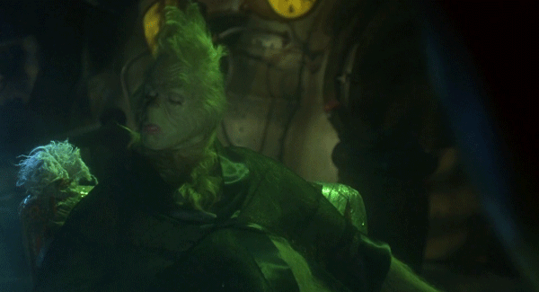 Grinch Close Up in Dark Room With Clock
