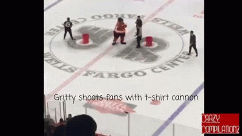 Gritty Shoots Fans With A T-Shirt Cannon During A Hockey Game GIF