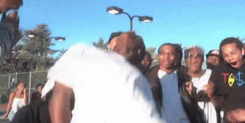 Group Around Dancing Man In White Shirt GIF
