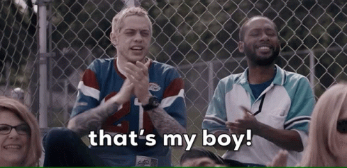 Group At Chain Link Fence Saying That's My Boy GIF