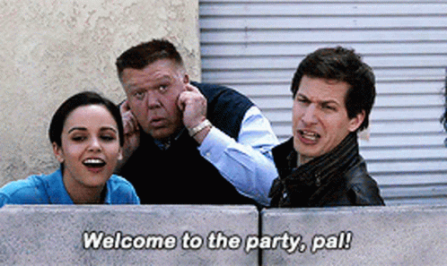 Group Behind Concrete Wall Saying Welcome to the Party Pal