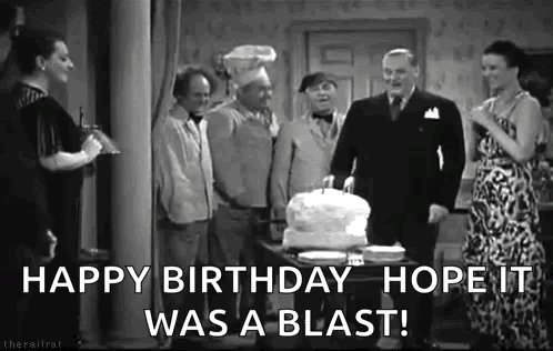 Group Celebrating Birthday With Cake
