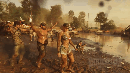 Group Covered in Mud Dancing With Mud Text