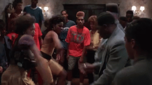 Group Dancing Around Man in Suit