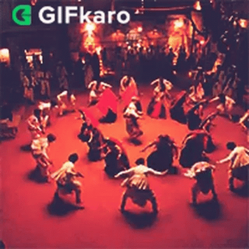 Group Dancing in Circle on Stage in Dark Room