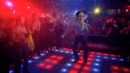 Group Dancing in Club With Man in Headphones