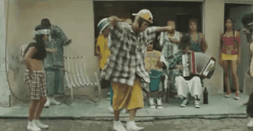 Group Dancing In Front Of Building With Accordion Player GIF