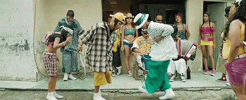 Group Dancing In Front Of Building With Accordion Player GIF