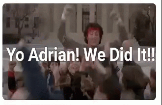 Group Dancing in Front of Building With Sign Saying Yo Adrian We Did It
