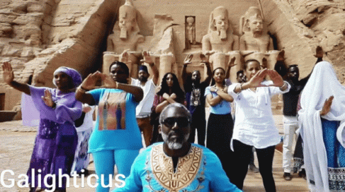 Group Dancing in Front of Statue Galighticus