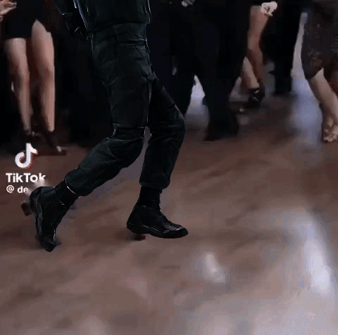 Group Dancing On Dance Floor With TikTok Logo GIF