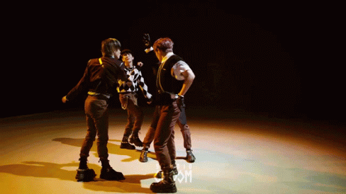 Group Dancing On Stage With Letter M GIF