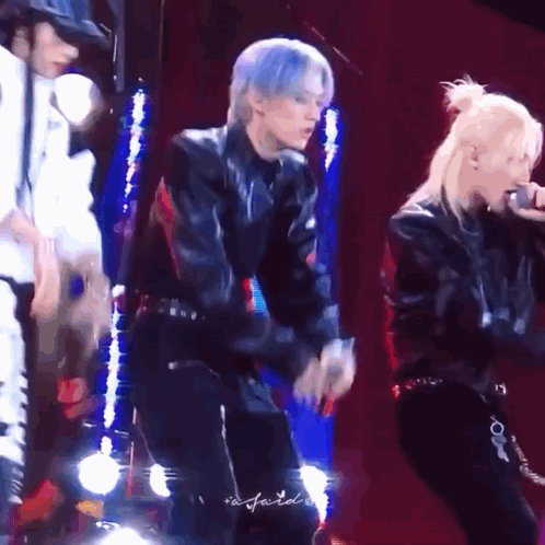 Group Dancing On Stage With One Singing Into Microphone GIF