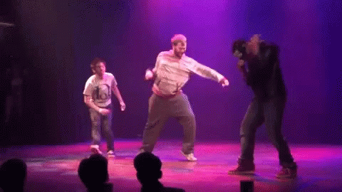 Group Dancing On Stage With Purple Lights GIF