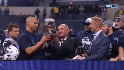 Group Holding Big Ten Championship Trophy