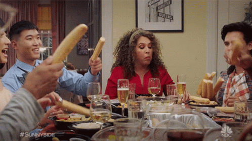 Group Holding Bread Sticks In Air GIF