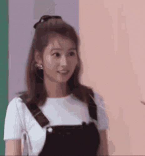 Group Holding Paper In Front Of Brick Building GIF
