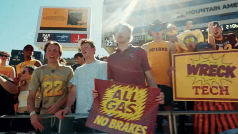 Group Holding Signs Saying All Gas No Brakes