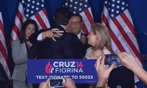 Group Hugging Man in Front of Cruz 16 Fiorina Sign