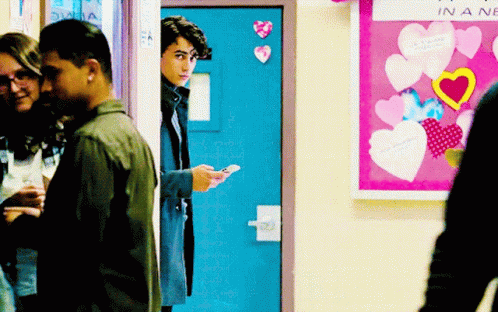 Group in Front of Bulletin Board Saying In a New