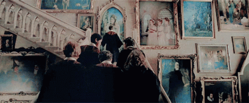 Group In Front Of Framed Pictures GIF