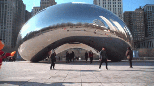 Group in Front of Large Metal Object