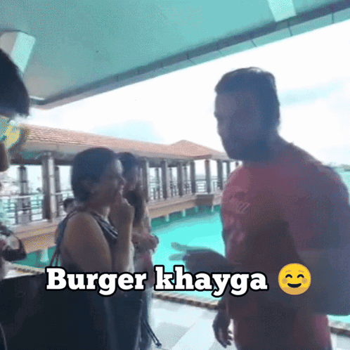 Group in Front of Swimming Pool With Burger Khayga Sign