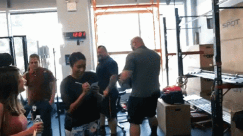 Group in Gym with 12:20 Clock