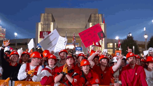Group in Hard Hats Holding Signs Saying Remember When You Were a Little Girl