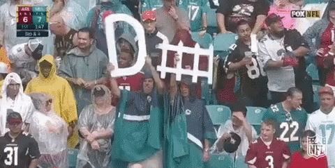 Group in Stadium Holding Sign Saying D