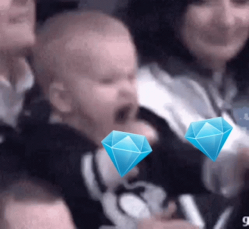 Group in Stadium With Two Blue Diamonds on Head