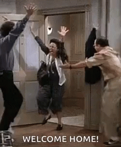 Group Jumping In Front Of Welcome Home Door GIF