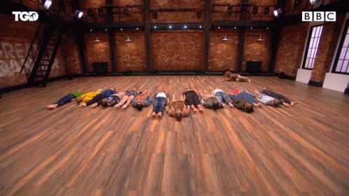 Group Lying On Backs On Wooden Floor With BBC GIF