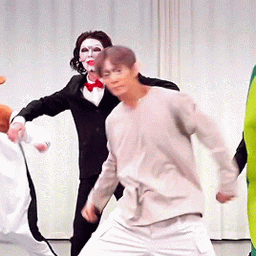 Group Of Costumed People Dancing GIF