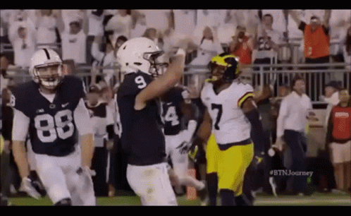 Group Of Football Players Standing On Field GIF