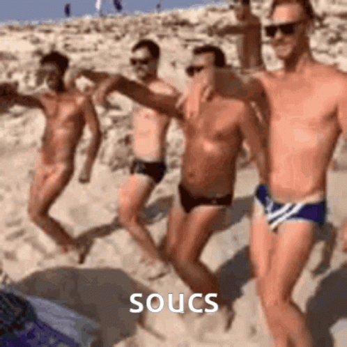 Group of Men Dancing on Beach Soucs