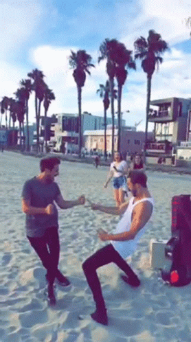 Group of Men Dancing on Sandy Beach
