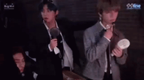 Group of Men Holding Microphones With Fan