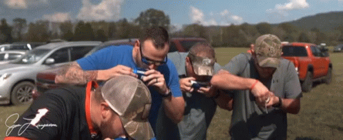 Group Of Men In Field One Wearing J. J. Jergens Shirt GIF