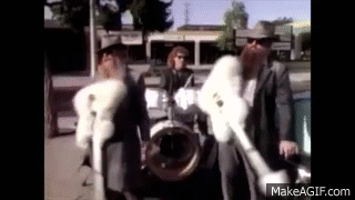 Group Of Men In Fur Coats On Street GIF