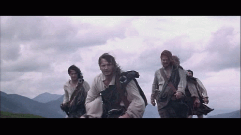 Group Of Men In Kilts Walking In Line GIF