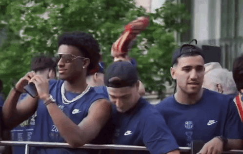 Group of Men in Nike Shirts Standing in Line