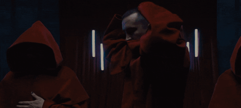 Group of Men in Red Hooded Cloaks