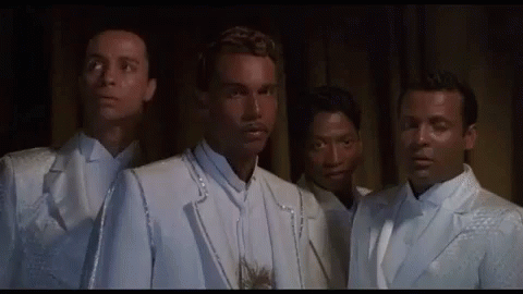 Group Of Men In White Suits And Ties Standing Together GIF