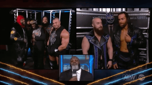 Group Of Men Next To Man In Suit With AEW Logo GIF