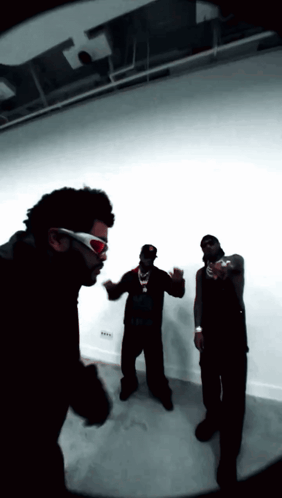 Group of Men One Wearing Sunglasses
