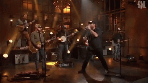 Group Of Men Playing Instruments On SNL Stage GIF