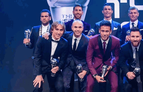 Group Of Men Posing With Trophies In Front Of FIFA Trophy GIF
