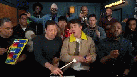 Group of Men Singing and Playing Xylophone