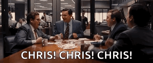 Group of Men Sitting Around Table With Chris Chris Chris